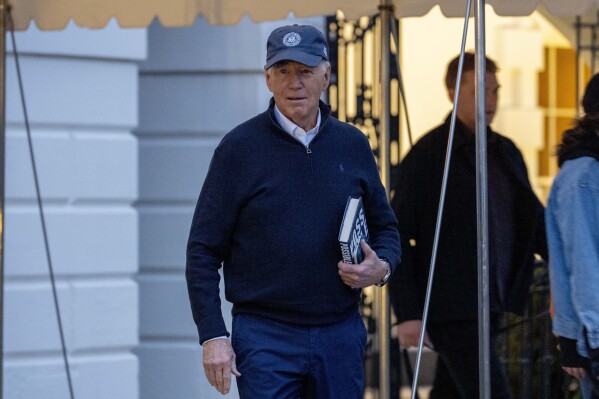 President Joe Biden walks towards members of the media before boarding Marine One on the South Lawn of the White House in Washington, Friday, March 1, 2024, to travel to Camp David, Md., for the weekend. (AP Photo/Andrew Harnik)