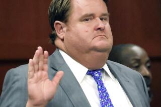 Political consultant Eric Foglesong raises his hand to be sworn-in to testify in an arraignment in Seminole Circuit Court in Sanford, Fla., Tuesday, Aug. 2, 2022. Foglesong pleaded not guilty to felony charges of misreporting contributions to a "ghost candidate" during the campaign for a Florida Senate seat in 2020. (Joe Burbank/Orlando Sentinel via AP)