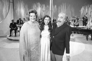 FILE - Conductor Mitch Miller performs for photographers with singers Rosemary Clooney, left, and Irene Cara, center, during a rehearsal, on Jan. 6, 1981, in New York for his NBC-TV special called "The Mitch Miller Show: A Sing Along Sampler."  Oscar, Golden Globe and two-time Grammy winning singer-actress Cara, who starred and sang the title cut from the 1980 hit movie “Fame” and then belted out the era-defining hit “Flashdance ... What a Feeling” from 1983's “Flashdance,” has died at age 63.  Her publicist Judith A. Moose confirmed the death on Saturday, Nov. 26, 2022. (AP Photo/Richard Drew, File)