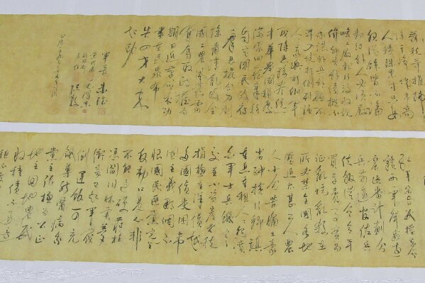 In this photo provided by Hong Kong Police Force, two pieces of a calligraphy scroll by former Chinese leader Mao Zedong estimated to be worth about $296.7 million are displayed in Hong Kong, Tuesday, Oct. 6, 2020. The South China Morning Post newspaper quoting an unnamed police source who reported that the calligraphy scroll was cut in half by a buyer who had purchased it for 500 Hong Kong dollars ($64.50) and had believed the scroll to be counterfeit. (Hong Kong Police Force via AP)