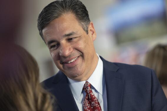 FILE - Idaho Attorney General candidate Raul Labrador talks with the media during the Republican Party's primary election celebration on May 17, 2022, in Boise, Idaho. Eight attorneys and a handful of other staffers have left or are leaving the Idaho attorney general's office following Labrador's win over five-term incumbent Attorney General Lawrence Wasden in the Republican primary in May. Labrador has promised to make the office more partisan should he win in next week's general election. (AP Photo/Kyle Green, File)
