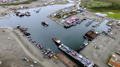 This photo provided by the City of Nome shows the inner harbor of the Port of Nome, Alaska, on Aug. 11, 2017, where goods at that arrive at the port are then prepared for shipment to villages throughout the region. Shipping lanes that were once clogged with ice for much of the year along Alaska's western and northern coasts have relented thanks to global warming, and the nation's first deep water Arctic port should be operational in Nome by the end of the decade. (Nome Harbormaster Lucas Stotts/City of Nome via AP)