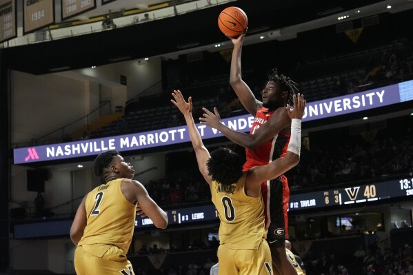 Georgia forward Dylan James (13) shoots over Vanderbilt guard Tyrin Lawrence (0) and forward Ven-Allen Lubin (2) during the second half of an NCAA college basketball game Wednesday, Feb. 21, 2024, in Nashville, Tenn. (APPhoto/George Walker IV)