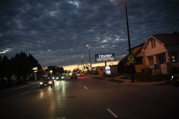 FILE - In this Oct. 31, 2020, file photo, a billboard for President Donald Trump is illuminated along a street in Kenosha, Wis. (AP Photo/Wong Maye-E, File)