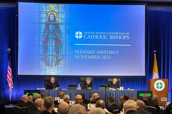 The nation’s Catholic bishops gather for their annual fall meeting in at the Marriott Waterfront hotel in Baltimore on Tuesday, Nov. 14, 2023. On Tuesday, the Catholic leaders called for peace in a war-torn world and unity amid strife within their own clerical ranks. (AP Photo/Tiffany Stanley)