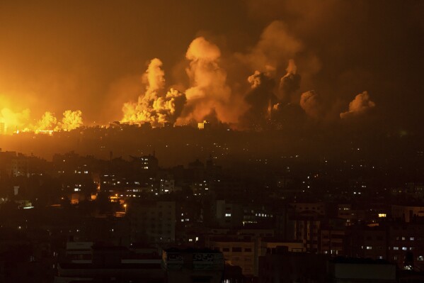 Fire and smoke rise following an Israeli airstrike, in Gaza City, Sunday, Oct. 8, 2023. The militant Hamas rulers of the Gaza Strip carried out an unprecedented, multi-front attack on Israel at daybreak Saturday, firing thousands of rockets as dozens of Hamas fighters infiltrated the heavily fortified border in several locations, killing hundreds and taking captives. Palestinian health officials reported scores of deaths from Israeli airstrikes in Gaza. (AP Photo/Fatima Shbair)