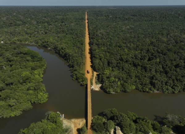 The trans-Amazon highway crosses the Assua River near the Juma Indigenous community near Canutama, Amazonas state, Brazil, Monday, July 10, 2023. The Juma seemed destined to disappear following the death of the last remaining elderly man, but under his three daughters’ leadership, they changed the patriarchal tradition and now fight to preserve their territory and culture. (AP Photo/Andre Penner)