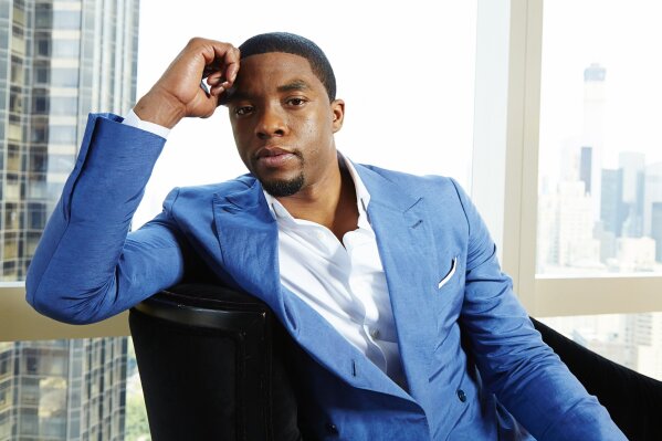 FILE - This July 21, 2014 file photo shows actor Chadwick Boseman posing for a portrait in New York.  Boseman, who played Black icons Jackie Robinson and James Brown before finding fame as the regal Black Panther in the Marvel cinematic universe, has died of cancer. His representative says Boseman died Friday, Aug. 28, 2020 in Los Angeles after a four-year battle with colon cancer. He was 43. (Photo by Dan Hallman/Invision/AP, File)