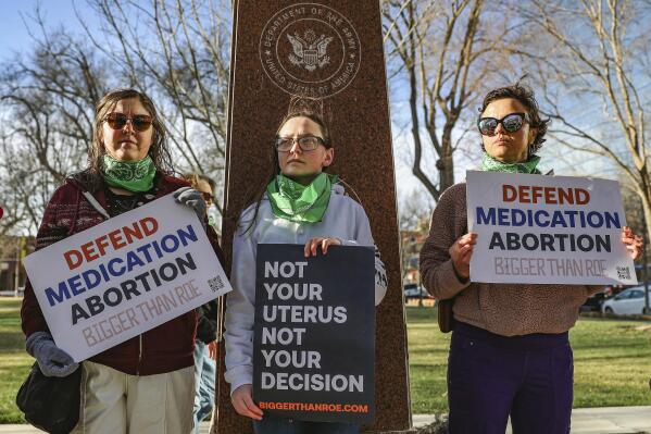 FILE - Three members of the Women's March group protest in support of access to abortion medication outside the Federal Courthouse on Wednesday, March 15, 2023 in Amarillo, Texas. Matthew Kacsmaryk, a Texas judge who sparked a legal firestorm with an unprecedented ruling halting approval of the nation's most common method of abortion, Friday, April 7, 2023, is a former attorney for a religious liberty legal group with a long history pushing conservative causes. (AP Photo/David Erickson)