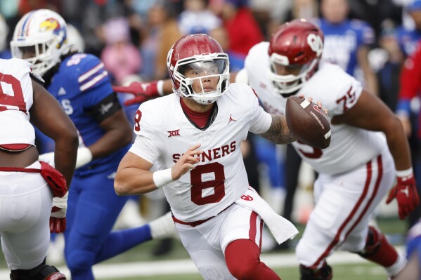 FILE - Oklahoma quarterback Dillon Gabriel (8) scrambles during the first half of the team's NCAA college football game against Kansas, Oct. 28, 2023 in Lawrence, Kan. Gabriel was selected to the The Associated Press Big 12 first team. (AP Photo/Colin E Braley, File)