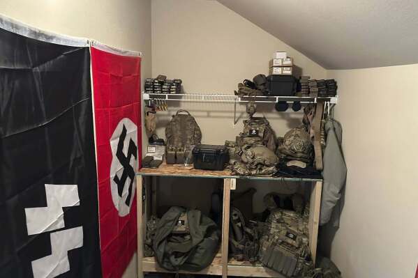 In this undated photo released by the Thurston County Sheriff's Office, a cache of military weaponry and Nazi paraphernalia are photographed during a raid at a home in Lacey, Wash. (Thurston County Sheriff's Office via AP)