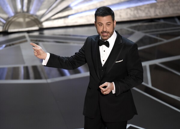 FILE - Host Jimmy Kimmel speaks at the Oscars in Los Angeles on March 4, 2018. Kimmel is returning as host of the Academy Awards, the Academy of Motion Pictures Arts and Sciences announced Wednesday. (Photo by Chris Pizzello/Invision/AP, File)