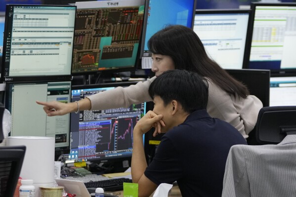 Currency traders watch monitors at the foreign exchange dealing room of the KEB Hana Bank headquarters in Seoul, South Korea, Thursday, Sept. 21, 2023. Asian shares are lower, tracking a slump on Wall Street after the Federal Reserve said it may not cut interest rates next year by as much as it earlier thought. (AP Photo/Ahn Young-joon)