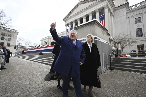 West Virginia Governor Patrick Morrisey and his wife, Denise, greet people following his swearing-in at the state capitol in Charleston, W.Va., on Monday, Jan. 13, 2025. (AP Photo/Chris Jackson)