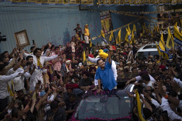FILE- Aam Aadmi Party leader Arvind Kejriwal greets his supporters from a vehicle during a roadshow in New Delhi, India, Saturday, May 11, 2024. (AP Photo/Altaf Qadri, File)
