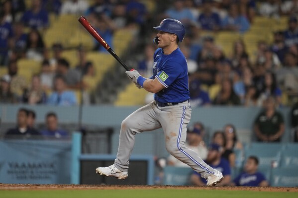 Toronto Blue Jays' Daulton Varsho follows through on his bases-loaded two-run double during the 11th inning of a baseball game against the Los Angeles Dodgers Monday, July 24, 2023, in Los Angeles. (AP Photo/Marcio Jose Sanchez)