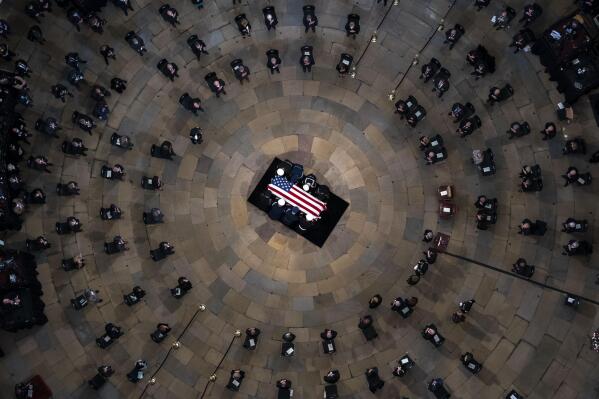 The casket of former Sen. Bob Dole, R-Kan., arrives in the Rotunda of the U.S. Capitol, where he will lie in state, Thursday, Dec. 9, 2021, on Capitol Hill in Washington. (AP Photo/Andrew Harnik, Pool)