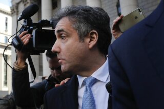 
              Michael Cohen walks out of federal court, Thursday, Nov. 29, 2018, in New York, after pleading guilty to lying to Congress about work he did on an aborted project to build a Trump Tower in Russia.  Cohen told the judge he lied about the timing of the negotiations and other details to be consistent with Trump's "political message." (AP Photo/Julie Jacobson)
            