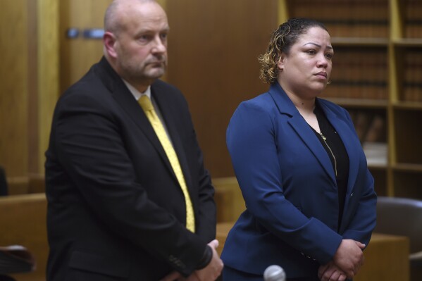 Former New Haven Police Sgt. Betsy Segui, right, with attorney, Gregory Cerritelli, appears in Superior Court in New Haven, Conn., on Thursday, March 28, 2024. Four former Connecticut police officers, including Segui, arrested for allegedly mistreating a man who wound up paralyzed in the back of a police van in 2022 were denied bids Thursday to enter a program that could have erased criminal charges against them and possibly let them avoid trial. (Arnold Gold/Hearst Connecticut Media via AP, Pool)