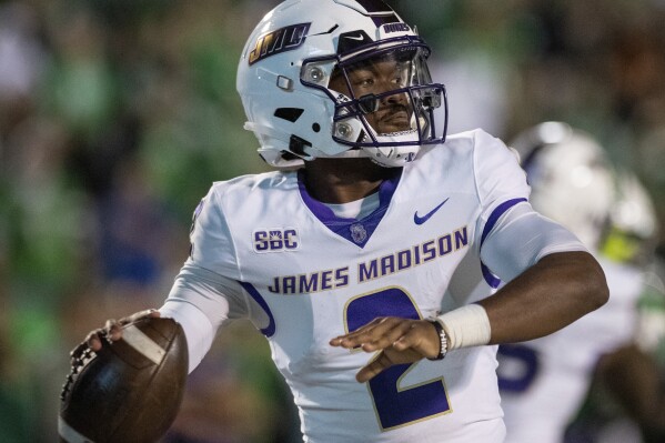 James Madison quarterback Jordan McCloud (2) looks for an open receiver during the second half of an NCAAcollege football game against Marshall in Huntington, W.Va., Thursday, Oct. 19, 2023. (Daniel Lin/Daily News-Record Via AP)/Daily News-Record via AP)