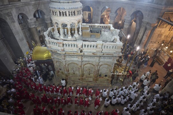 Roman Catholic clergymen carry palm fronds during the Palm Sunday procession at the Church of the Holy Sepulchre, traditionally believed by many to be the site of the crucifixion and burial of Jesus Christ, in Jerusalem's Old City, Sunday, April 13, 2025. (AP Photo/Ohad Zwigenberg)