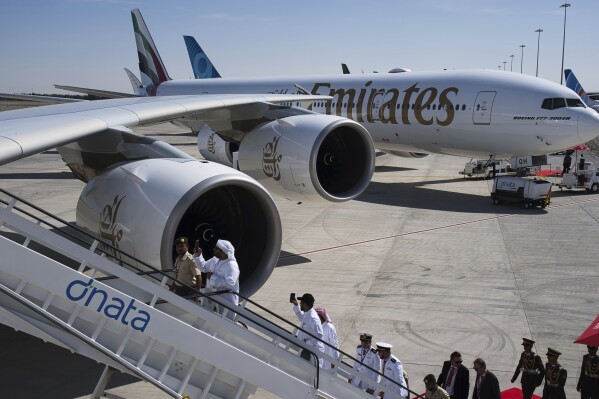 Visitors take photos at the Dubai Air Show in Dubai, United Arab Emirates, Monday, Nov. 13, 2023. Long-haul carrier Emirates opened the Dubai Air Show with a $52 billion purchase of Boeing Co. aircraft, showing how aviation has bounced back after the groundings of the coronavirus pandemic, even as Israel's war with Hamas clouds regional security. (AP Photo/Jon Gambrell)