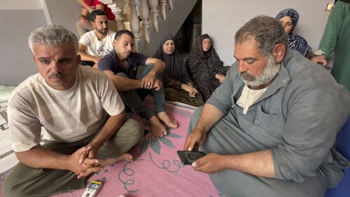 Saleh: Mohammed Saleh, the father of 18-year-old Yahia Saleh, holds a phone with a photo of his son at home in Ibrash, Egypt, Sunday, June 18, 2023. Yahia is one of dozens from the village feared to have drowned after a packed fishing vessel sank off Greece on June 14. There were as many as 750 migrants, including women and children, on board the trawler, which capsized and sank off Greece in one of the deepest parts of the Mediterranean Sea instead of docking in Italy. (AP Photo)