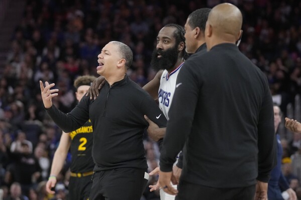 Los Angeles Clippers coach Tyronn Lue, left, is held back by guard James Harden after being called for a technical foul during the second half of the team's NBA basketball game against the Golden State Warriors in San Francisco, Wednesday, Feb. 14, 2024. (AP Photo/Jeff Chiu)