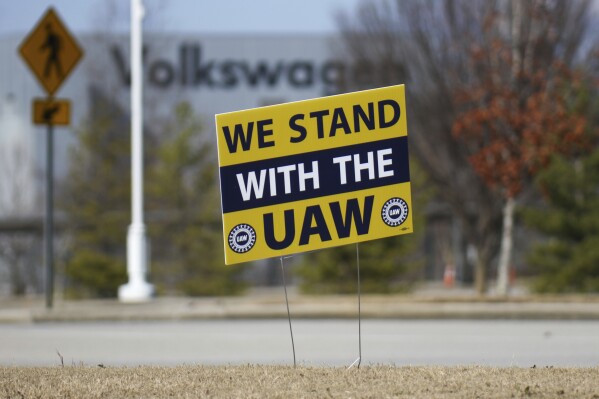 FILE - A "We stand with the UAW" sign appears outside of the Volkswagen plant in Chattanooga, Tenn., on Dec. 18, 2023. Workers at at the Tennessee factory are scheduled to finish voting Friday, April 19, 2024, on whether they want to be represented by the United Auto Workers union. (Olivia Ross/Chattanooga Times Free Press via AP, File)