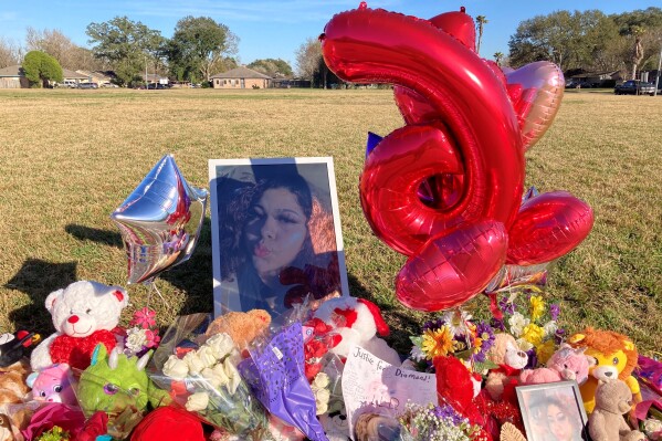 FILE - A makeshift memorial sits near the side of a street, Jan 13, 2022, in Houston, next to a large grassy area where Diamond Alvarez was fatally shot. Family members of the murdered 16-year-old girl attacked her ex-boyfriend during a court hearing Tuesday, Oct. 17, 2023, after he had pleaded guilty to shooting her nearly two dozen times while she was walking her dog. (AP Photo/Juan Lozano, File)