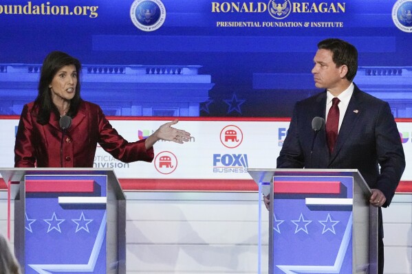 FILE - Republican presidential candidate and former U.N. Ambassador Nikki Haley, left, with Florida Gov. Ron DeSantis, speaks during a Republican presidential primary debate hosted by FOX Business Network and Univision, Sept. 27, 2023, at the Ronald Reagan Presidential Library in Simi Valley, Calif. Haley has been rising with donors and voters thanks in part to strong debate performances and the campaign's increased focus on foreign policy. That's come partly at the expense of Florida Gov. Ron DeSantis. But donors and voters seeking an alternative to former President Donald Trump haven't fully coalesced around Haley. (AP Photo/Mark J. Terrill, File)