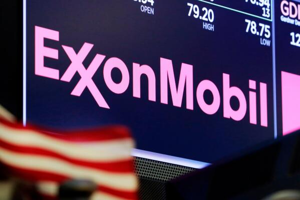 FILE - The logo for ExxonMobil appears above a trading post on the floor of the New York Stock Exchange on April 23, 2018. The U.S. government said in a lawsuit filed Thursday, March 2, that ExxonMobil Corp. violated federal law for failing to take sufficient action after five hangman’s nooses were displayed at its facility in Baton Rouge, La. (AP Photo/Richard Drew, File)