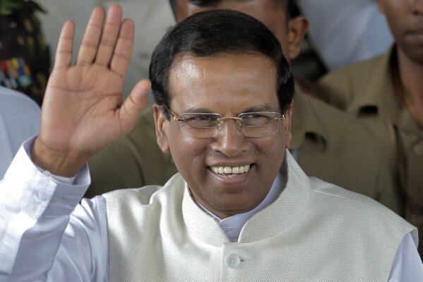 
              FILE - In this Jan. 9, 2015 file photo, Sri Lanka's then-incoming President Maithripala Sirisena waves to supporters as he leaves the election secretariat in Colombo, Sri Lanka. Sri Lanka’s president on Sunday assured non-interference in ongoing investigations into abductions, killings of journalists and other crimes allegedly committed by those connected to the new prime minister and his Cabinet. (AP Photo/Eranga Jayawardena, File)
            