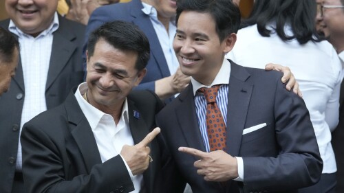 FILE - In this May 17, 2023 photo, leader of Pheu Thai party Chonlanan Srikaew, left gestures with the leader of Move Forward Party Pita Limjaroenrat, in Bangkok, Thailand. Thailand Politics Newly elected lawmakers in Thailand gathered Monday for the opening session of Parliament, which is tasked with selecting a new prime minister after May's general election saw the country's progressive Move Forward Party unexpectedly come out on top. (AP Photo/Sakchai Lalit)