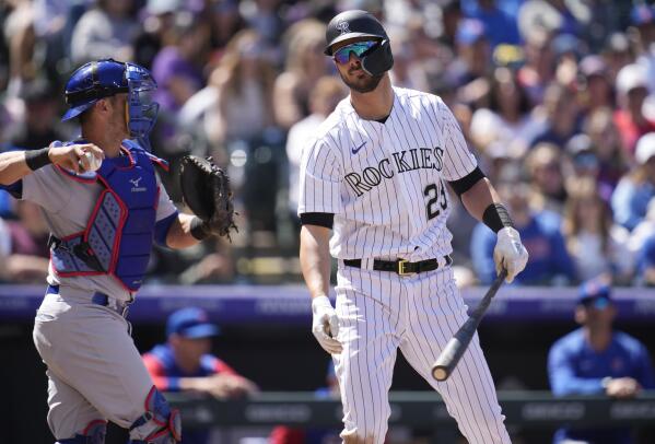 Colorado Rockies' Kris Bryant, right, reacts after striking out as Chicago Cubs catcher Yan Gomes heads to the dugout to end the third inning of a baseball game, Sunday, April 17, 2022, in Denver. (AP Photo/David Zalubowski)