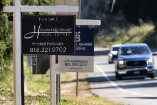File - Home sale signs are posted along Topanga Canyon road in Los Angeles on Oct. 19, 2023. On Tuesday, the National Association of Realtors on reports on existing home sales for October. (AP Photo/Richard Vogel, File)