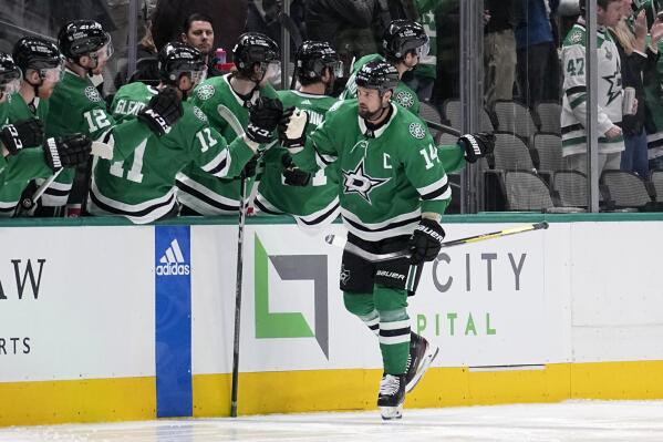 Dallas Stars left wing Jamie Benn (14) is congratulated after scoring during the second period of the team's NHL hockey game against the Minnesota Wild, Wednesday, Feb. 8, 2023, in Dallas. (AP Photo/Tony Gutierrez)