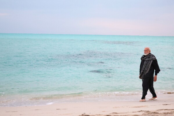 In this photograph released on Indian Prime Minister Narendra Modi's social media platform X on Jan.4, 2024, Modi, walks on a beach in Lakshadweep, India. Relationship between India and the Maldives is facing challenges after officials in the tiny island nation made derogatory remarks against Prime Minister Narendra Modi’s posts that promoted the pristine beaches of India’s Lakshadweep archipelago. (Narendra Modi's social media platform X via AP)