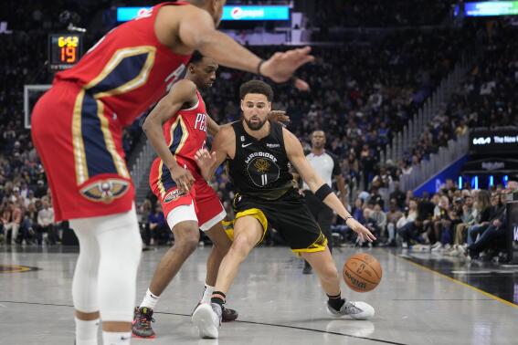 Golden State Warriors guard Klay Thompson (11) tries to get past New Orleans Pelicans forward Herbert Jones during the first half of an NBA basketball game in San Francisco, Friday, March 3, 2023. (AP Photo/Godofredo A. Vásquez)