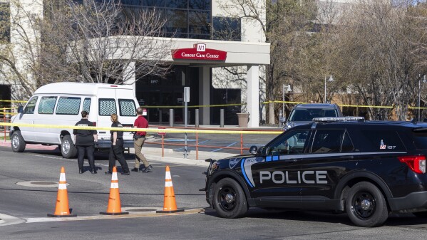 A police vehicle is parked outside Saint Alphonsus Regional Medical Center in Boise, Idaho, on Wednesday, March 20, 2024. Three Idaho corrections officers were shot as a suspect staged a brazen attack to break Skylar Meade, a prison inmate out of the Boise hospital overnight. Two of the officers were shot by the suspect early Wednesday. The third was shot and wounded by a police officer when police mistook the correctional officer for the suspect. (Sarah A. Miller/Idaho Statesman via AP)