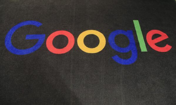 FILE - The logo of Google is displayed on a carpet at the entrance hall of Google France in Paris, on Nov. 18, 2019. Google said Friday, jan. 20, 2023, it’s laying off 12,000 workers, becoming the latest tech company to trim staff after rapid expansions during the COVID-19 pandemic have worn off. (AP Photo/Michel Euler, File)