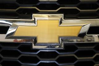 FILE - The Chevrolet logo is displayed at the 2020 Pittsburgh International Auto Show Thursday, Feb.13, 2020 in Pittsburgh.   General Motors is recalling more than 484,000 large SUVs in the U.S., Tuesday, Aug. 16, 2022, to fix a problem that can cause the third-row seat belts to malfunction. The recall covers Chevrolet Suburbans and Tahoes, Cadillac Escalades and GMC Yukons from 2021 and 2022. (AP Photo/Gene J. Puskar, File)