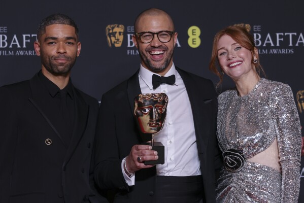 Kingsley Ben-Adir, from left, Cord Jefferson, winner of the adapted screenplay award for 'American Fiction', and Bryce Dallas Howard, pose for photographers at the 77th British Academy Film Awards, BAFTA's, in London, Sunday, Feb. 18, 2024. (Photo by Vianney Le Caer/Invision/AP)