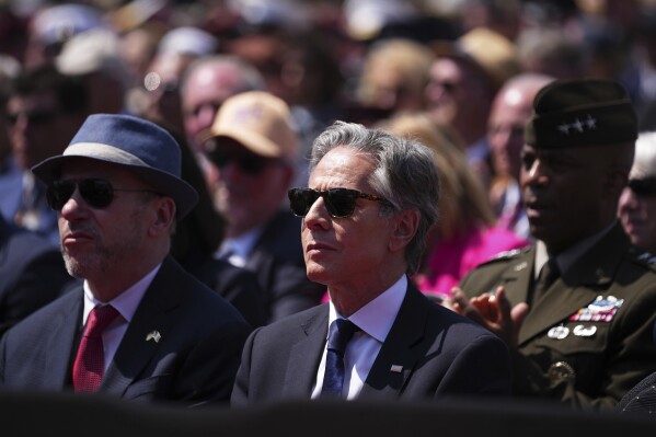 United States Secretary of State Antony Blinken listens to a speech during a commemorative ceremony to mark D-Day 80th anniversary, Thursday, June 6, 2024 at the US cemetery in Colleville-sur-Mer, Normandy. Normandy is hosting various events to officially commemorate the 80th anniversary of the D-Day landings that took place on June 6, 1944. (AP Photo/Daniel Cole, Pool)