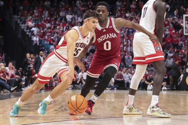 Arizona guard Kerr Kriisa (25) drives against Indiana guard Xavier Johnson (0) during the second half of an NCAA college basketball game Saturday, Dec. 10, 2022, in Las Vegas. (AP Photo/Chase Stevens)