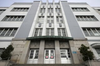 FILE - In this March 12, 2020, file photo, George Washington High School stands in San Francisco. As millions of California children are already back in the virtual classroom, families, teachers and districts are still scrambling to figure out some of the basics: How and when they can resume in-person learning and how to get the in-demand technology needed for distance learning in the meantime. (AP Photo/Jeff Chiu, File)