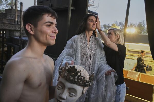 Performers of the Greek National Opera Denia Mimerini, center, and Nikos Egglezos, left, prepare ahead of Giacomo Puccini's "Turandot" during the 70th Athens Epidaurus Festival at the Odeon of Herodes Atticus in Athens, Greece, Tuesday, June 3, 2025. (AP Photo/Thanassis Stavrakis)