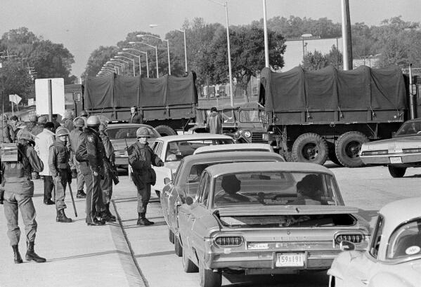 FILE - National Guardsmen and state troopers stop all traffic trying to enter the campus of Southern University at Baton Rouge, La., Nov. 17, 1972. Louisiana Gov. John Bel Edwards has issued an official apology for the deaths of two students who were shot by a law enforcement officer 50 years earlier during a protest at Southern University. (AP Photo/Jack Thornell, File)