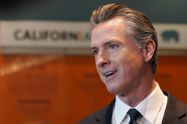 FILE - California Gov. Gavin Newsom talks to reporters after voting in Sacramento, Calif., Tuesday, Nov. 8, 2022. Newsom has agreed to release $1 billion in state homelessness funding he testily put on pause earlier this month. But his office says he will do so only if local governments agree to step up the aggressiveness of their plans going forward to reduce homelessness. (AP Photo/Rich Pedroncelli,File)