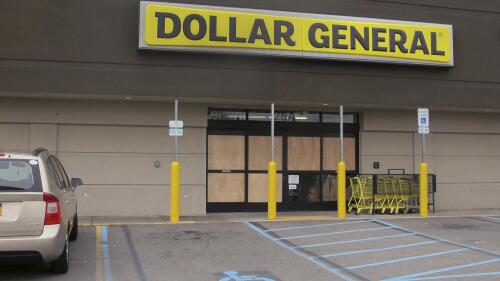 FILE - The glass doors of this Dollar General store in Cheektowaga, N.Y., are boarded up on Nov. 15, 2017, after being shattered by a gunman's bullets the day before. Travis Green, 34, who opened fire with a high-powered rifle at a Buffalo-area retail store in 2017, wounding one person, pleaded guilty to an attempted murder charge Thursday, May25, 2023, and agreed to serve a 10-year prison sentence. (AP Photo/Carolyn Thompson, File)